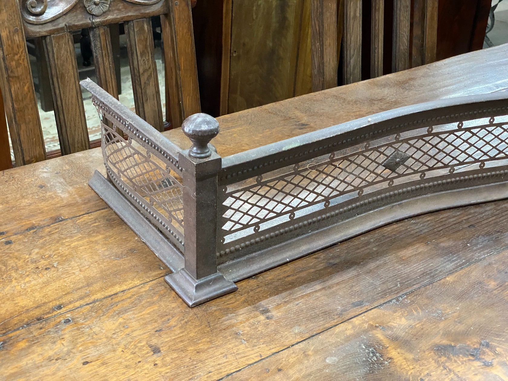 A George III serpentine steel fire curb, width 158cm